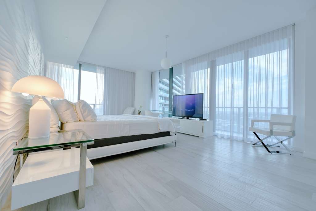 Bright bedroom with floor-to-ceiling windows