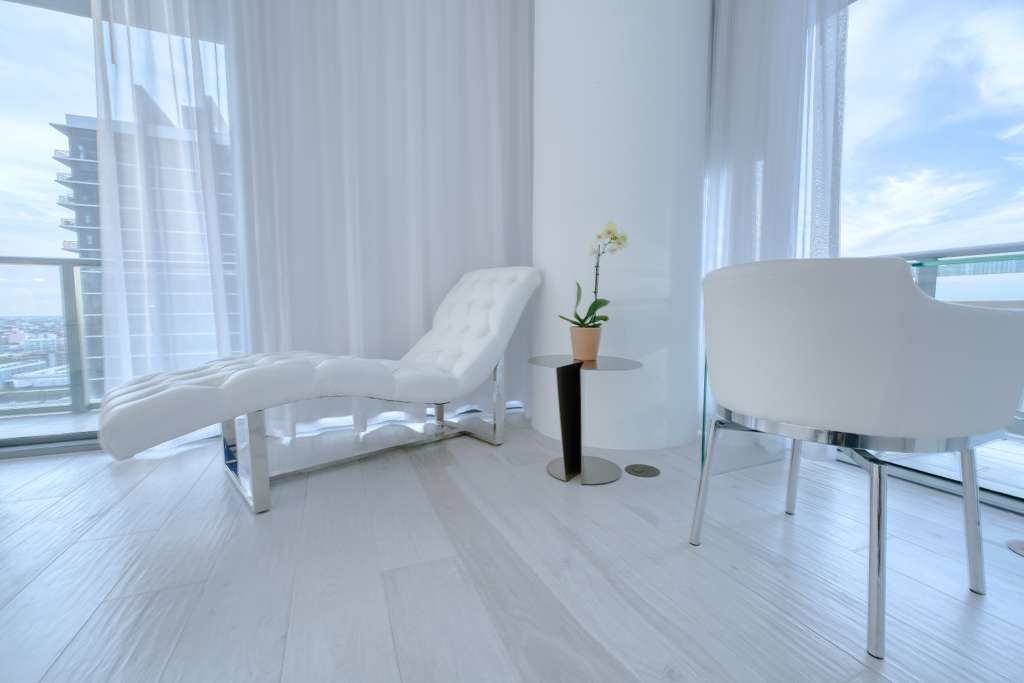 Bedroom sitting area beside expansive windows